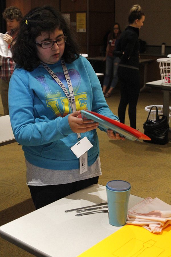 Freshman Alyssa Frias picks up plates to put them in the correct position while competing in the table setting event.