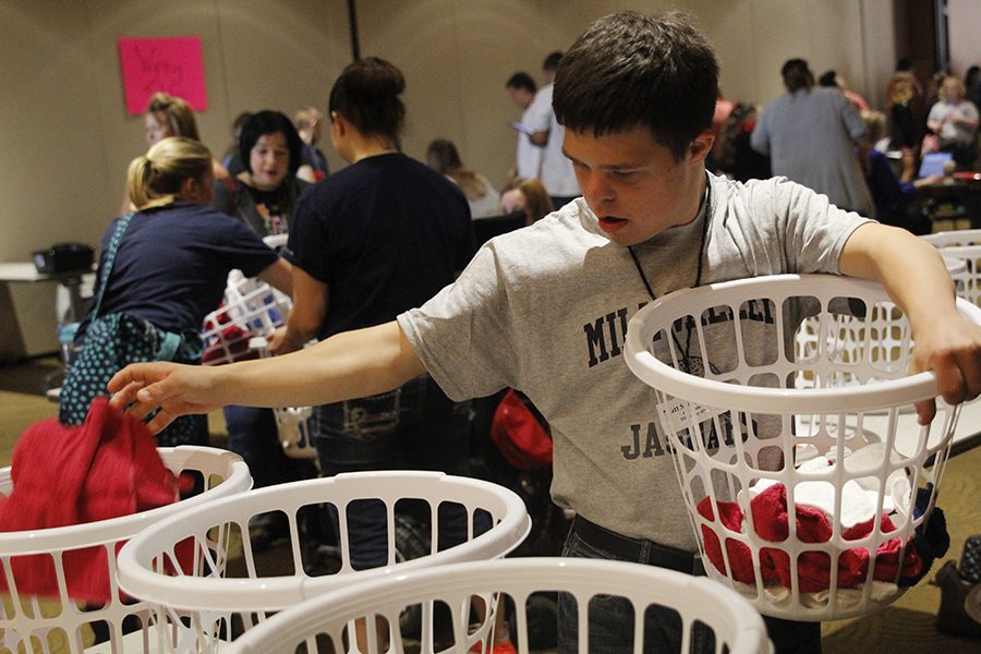 Sophomore Matt Santaularia sorts red, white and blue towels during the laundry sorting event.