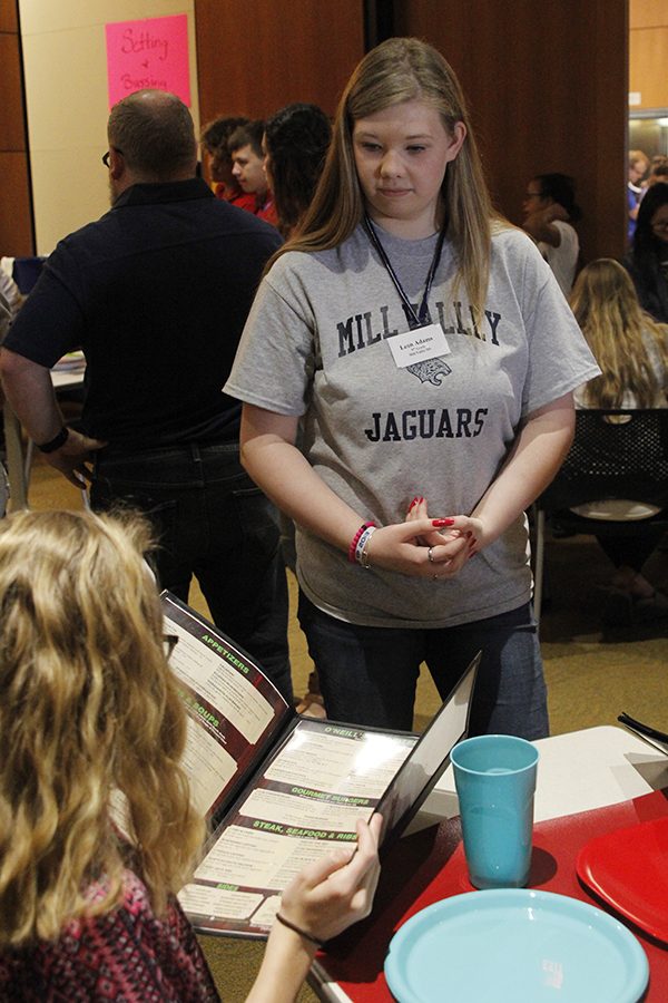 Freshman Leah Adams seats volunteers during her hostess event.