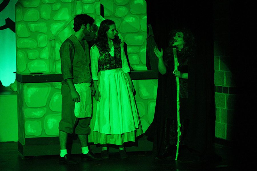 The witch, played by sophomore Lindsey Edwards, explains a task to the baker, played by junior Simon Stewart, and his wife, played by senior Lisa Earlenbaugh.