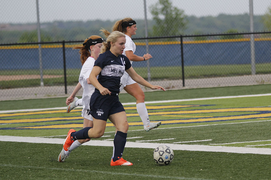 With an Aquinas defender on her back, junior Adde Hinkle looks to create a scoring opportunity during the second half of Mill Valleys 1-0 win over St. Thomas Aquinas on Tuesday, April 25.