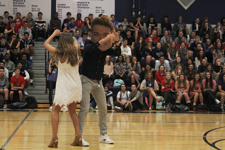 Bumping into each other, senior Spencer Butterfield, standing in for senior Braden Shaw, and senior Claire Rachwal celebrate being selected as prom candidates.