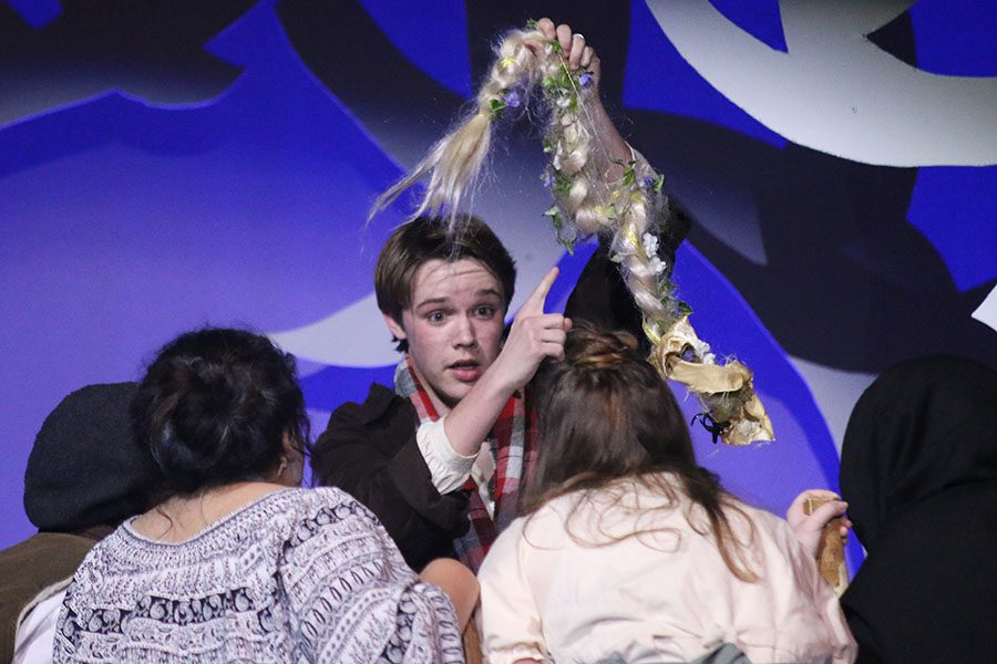 The Baker, played by junior Tyler Orbin, points to the yellow hair before feeding it to Milky White.