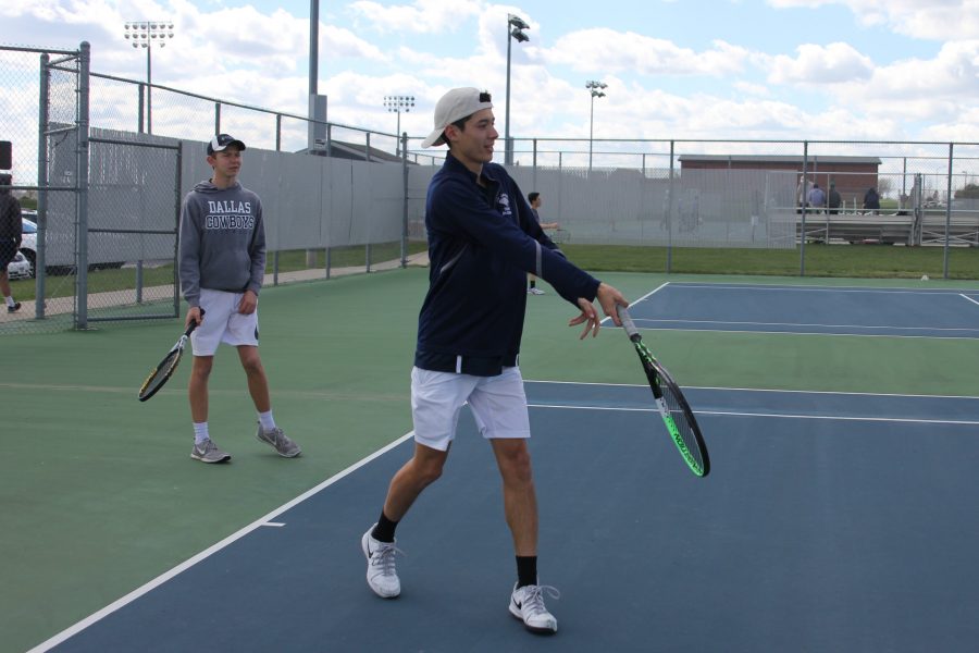 Leisurely receiving a ball, junior Drake Brizendine goes for an underhand swing.