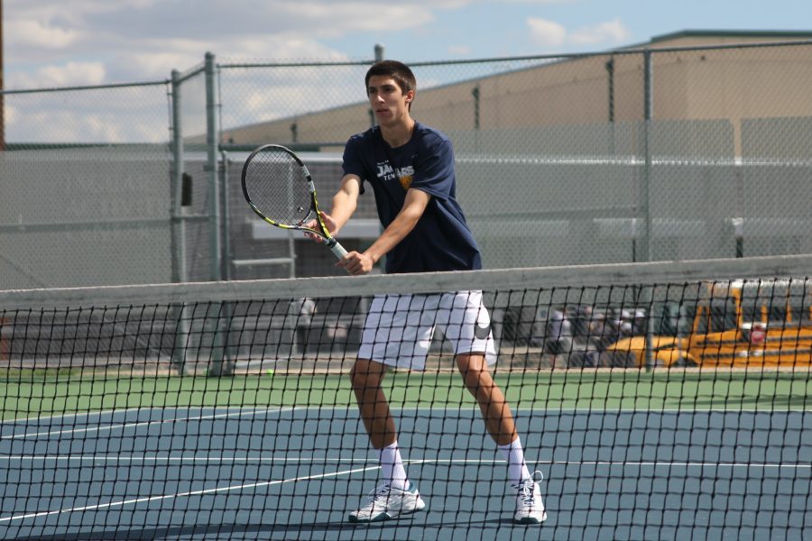 Preparing to secure success, senior Andrew Bock sets his stance and locks his eyes on the ball.