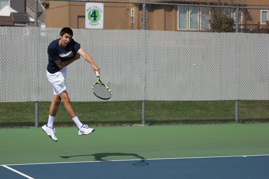 With a powerful start, senior Andrew Bock puts his all into a serve to start the match on Thursday, March 6.