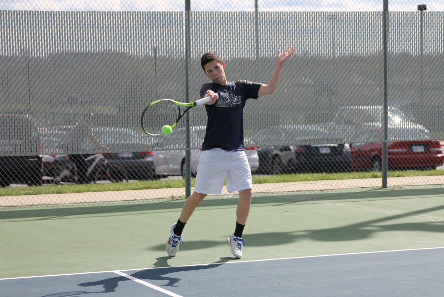 In a quick receive, sophomore Eric Schanker swings to hit the ball back to the other side.