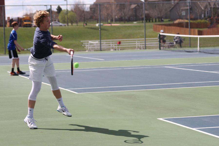 To keep the other team from scoring, junior Dante Peterson quickly hits the ball that flew across the court.