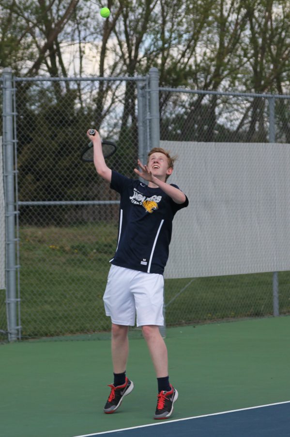 Starting off the play, junior Landon Butler serves.