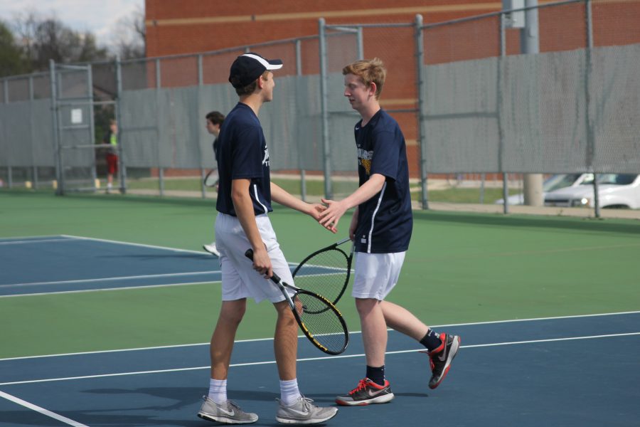 After a successful play, juniors Erich Shulz and Landon Butler high-five to celebrate.