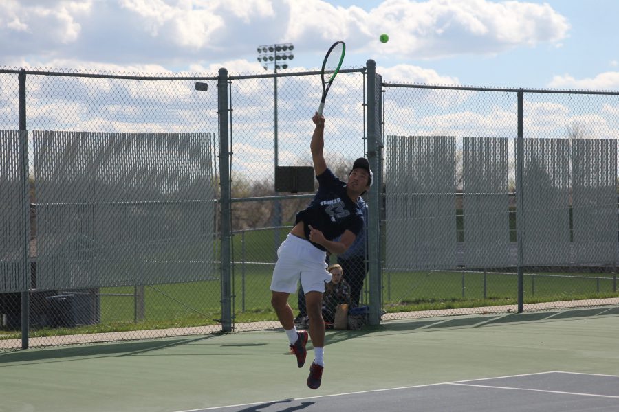 In order to receive a powerful serve, Senior parker billings jumps to return the ball.