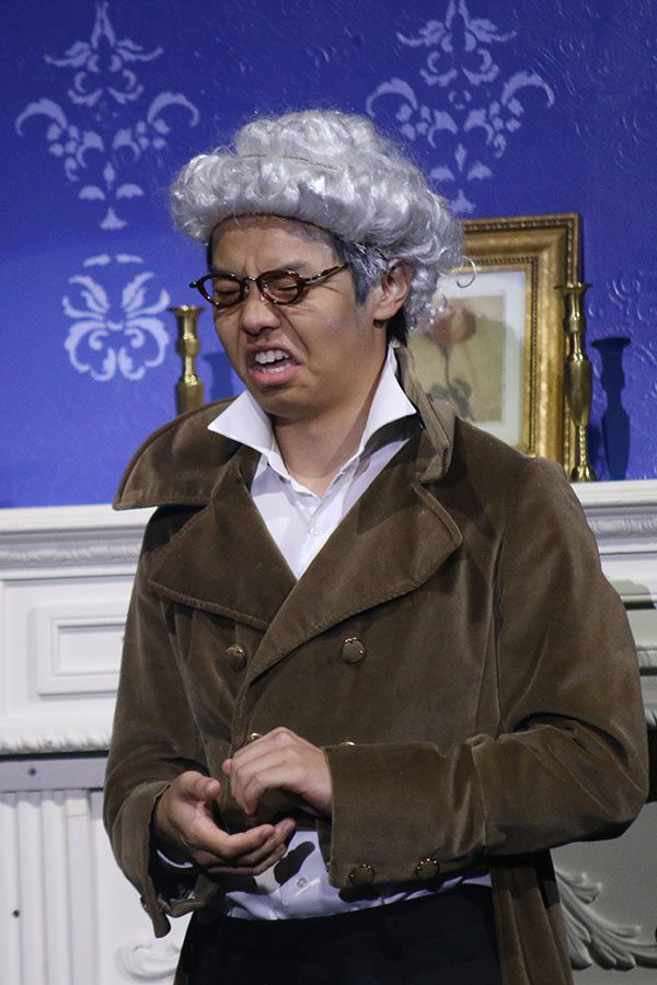 Cinderella's father, played by senior Jason Chen, talks to his daughter.