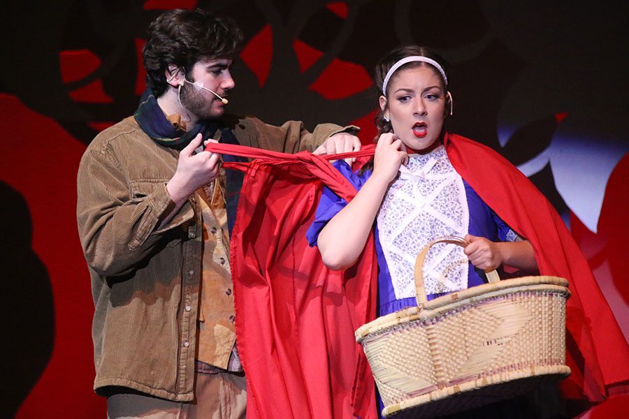 The Baker, played by junior Simon Stewart, takes off Little Red Riding Hood's cape, played by senior Kara Mason.