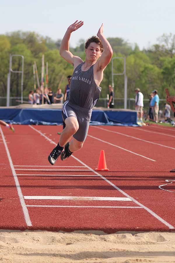 In the triple jump, sophomore Steven Colling jumps into the sand pit.