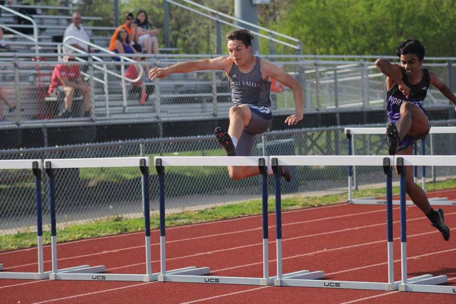 Junior Jack Turner attempts to jump over a hurdle.