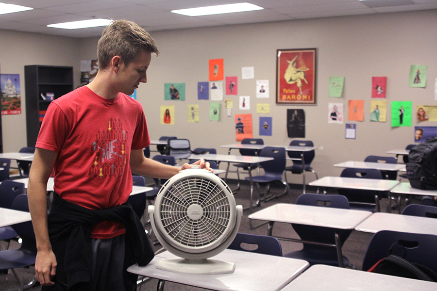 Adjusting the fan, sophomore Eric Niewohner tries to compensate for the air conditioning.