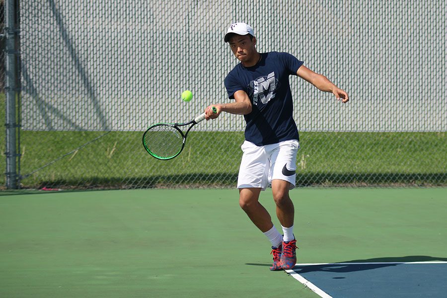 Running forward, senior Parker Billings prepares to hit the ball across the court on Wednesday, April 19.