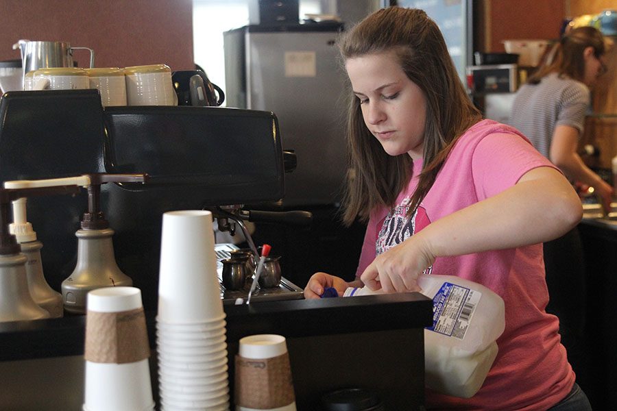 While working a shift at Country Club Cafe, senior Kristen Schau makes a specialty espresso drink for a customer on Sunday, March 26