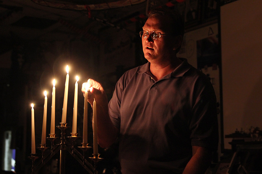 Archeology and Artifacts teacher Keil Hileman uses the 100-year-old candelabra he found in an abandoned church in a light demonstration for his class on Thursday, April 21.  “I used to get $100 from each high school, and now I get nothing. I used to get free busing, and now there’s going to have to be a course fee,” Hileman said. “But I don’t care and I will make it work. And I have had people tell me ‘if you need something, just call me.’ I’m still doing OK.”