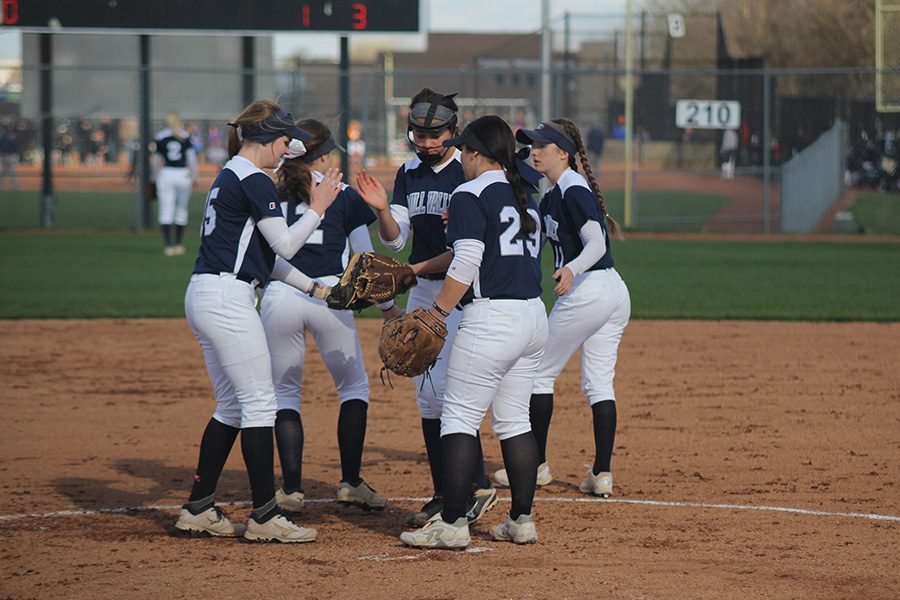 The team does a handshake after a group huddle on Thursday, April 6. The Jags fell in the first game against the Blue Valley Tigers 7-4 but came back to win the second game 12-1.