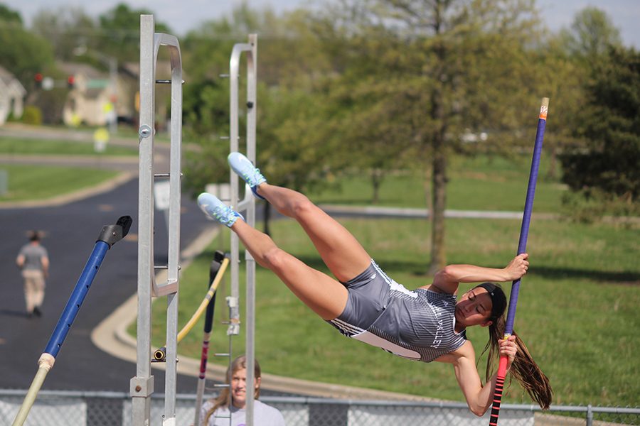 Launching herself feet-first over the bar, freshman Ellie Kerstetter focuses on completing her vault.