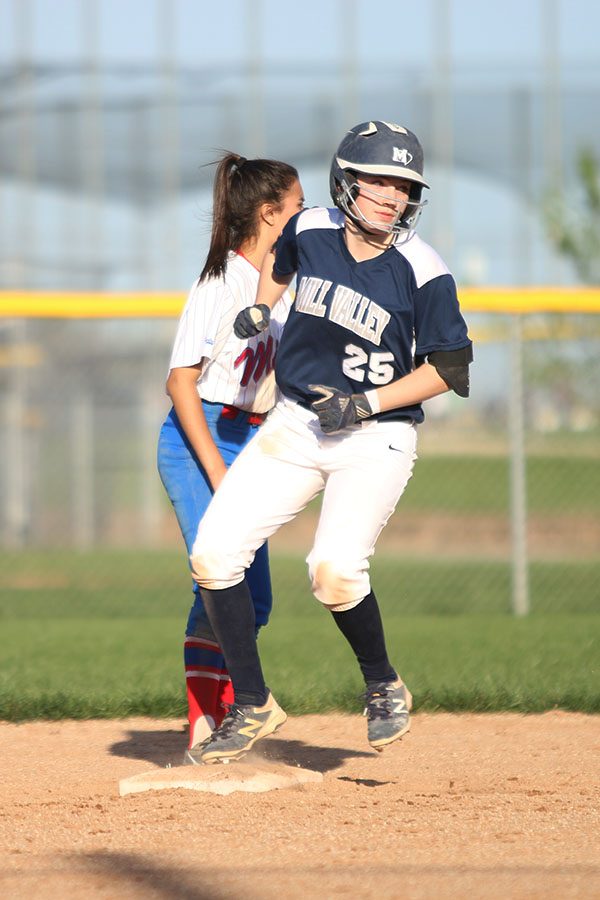 Watching the batter, sophomore Grace Lovett runs from second base.