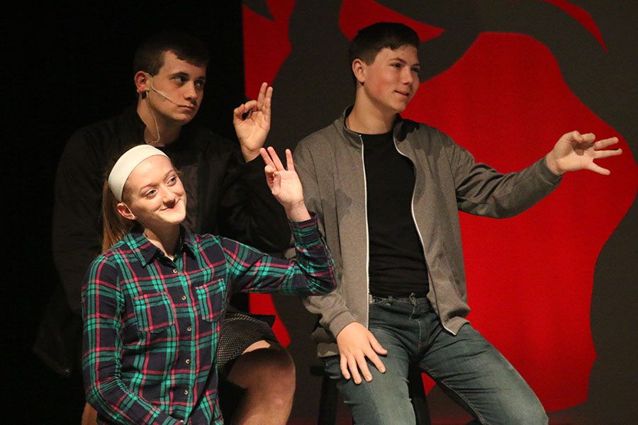 Aunt Gladys' family, played by sophomore Ally Appl, junior Mason Cole and sophomore Jack Jaworski, holds up a hand gesture.