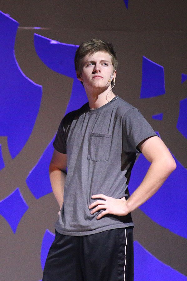 Travis, played by senior Marc Hinnen, poses while the girls admire him.