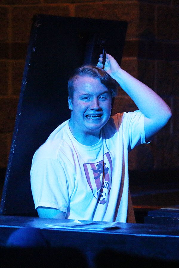 Norm, played by junior Hunter Tener, appears out of the trap door.