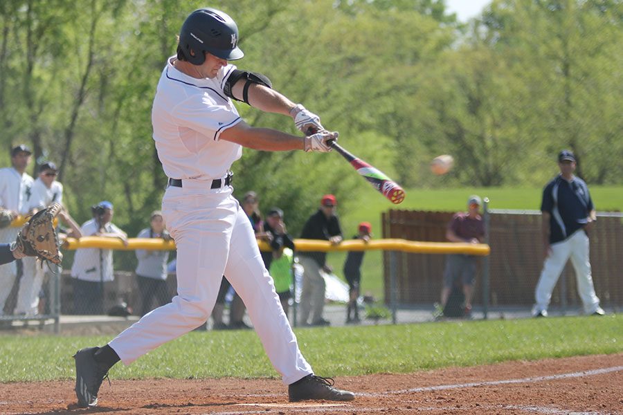 Swinging the bat, senior Luke Sosaya makes contact with the ball.