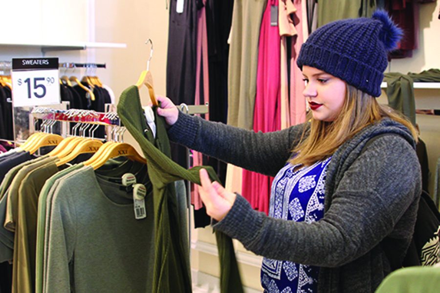 While in Forever 21 on the Plaza, sophomore Lindsey Edwards considers a shirt on Wednesday, March 15. 