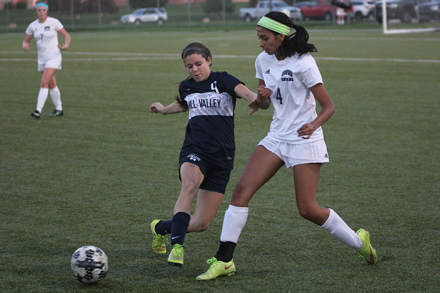 Sophomore Lexi Crocker defends a Raven player.