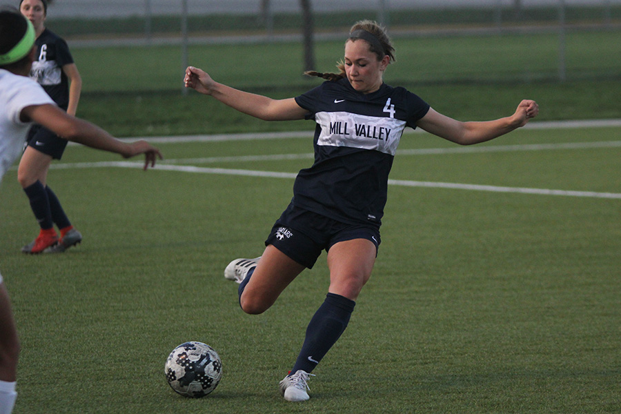 After setting up the ball, freshman Ella Shurley passes it to a teammate.