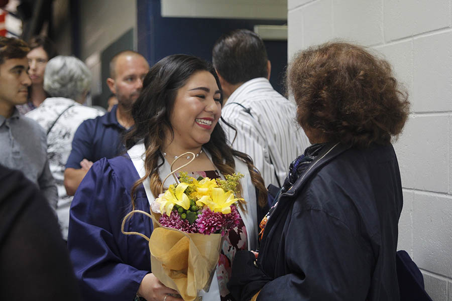 After she graduated, senior Alina Garcia laughs with her grandmother on Saturday, May 20.