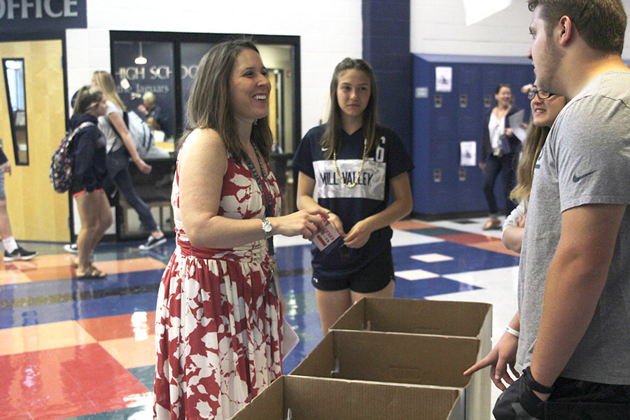Donating to the Noah’s Bandage Project drive, Social Studies teacher Angie DalBello smiles as she chats with Junior Preston Cole on Friday, April 21

