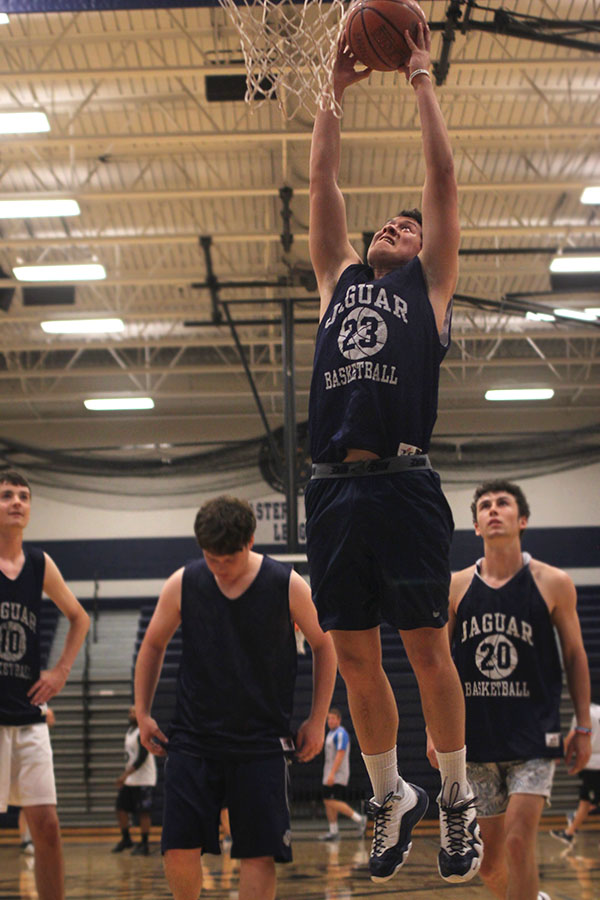 While warming up, senior Rowdy Boatwright goes up for a dunk. 