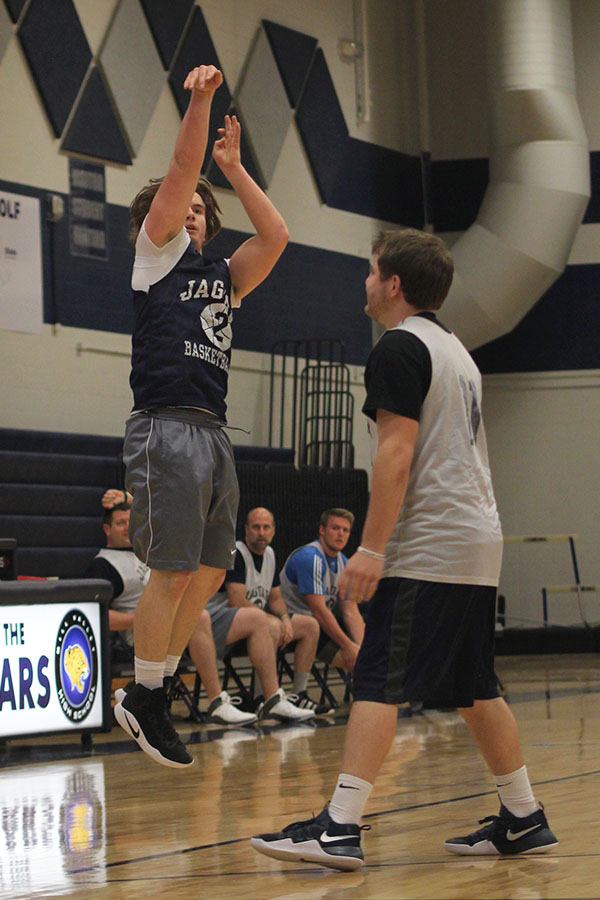 After dribbling down court, senior Josh Winscott shoots the ball.