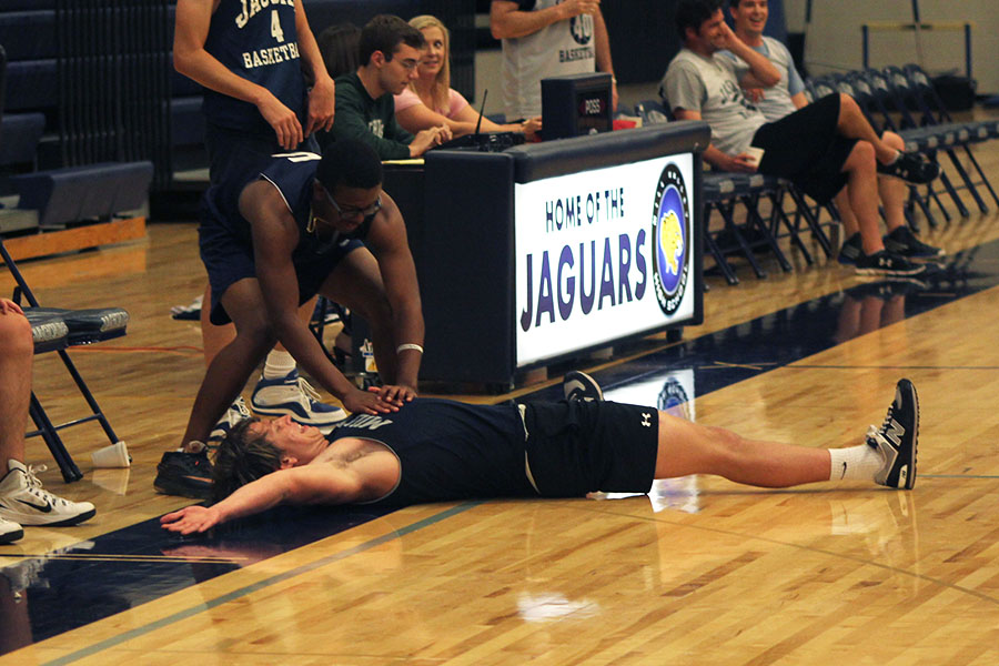 After their team shot a 3-pointer, senior Josh Hill pretends to resuscitate senior Chris Weber. 