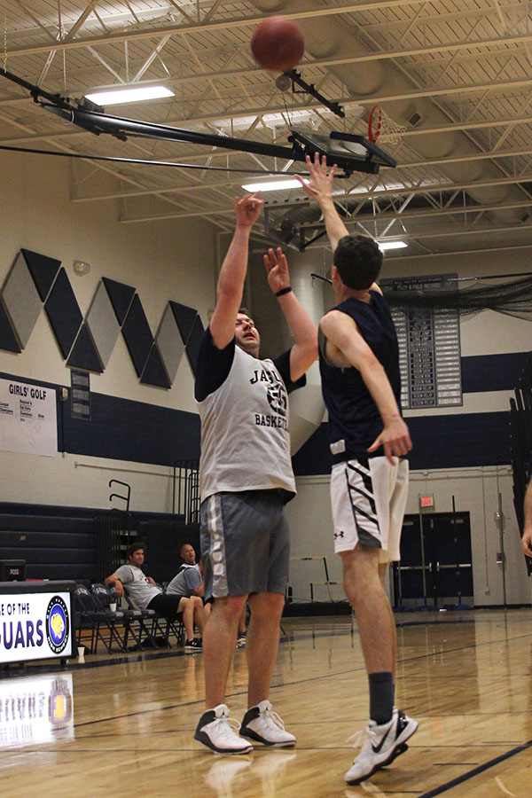 Math teacher Alex Houlton shoots the ball. 