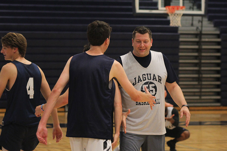 After the game, senior Drew Fauth motions to shake hands with math teacher Alex Houlton.