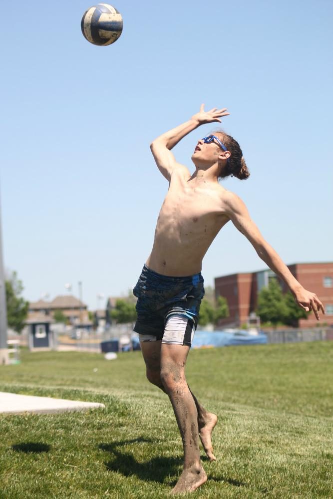 During a practice with his team before their game, sophomore Dylan Wootton spikes the ball back towards his teammates. 