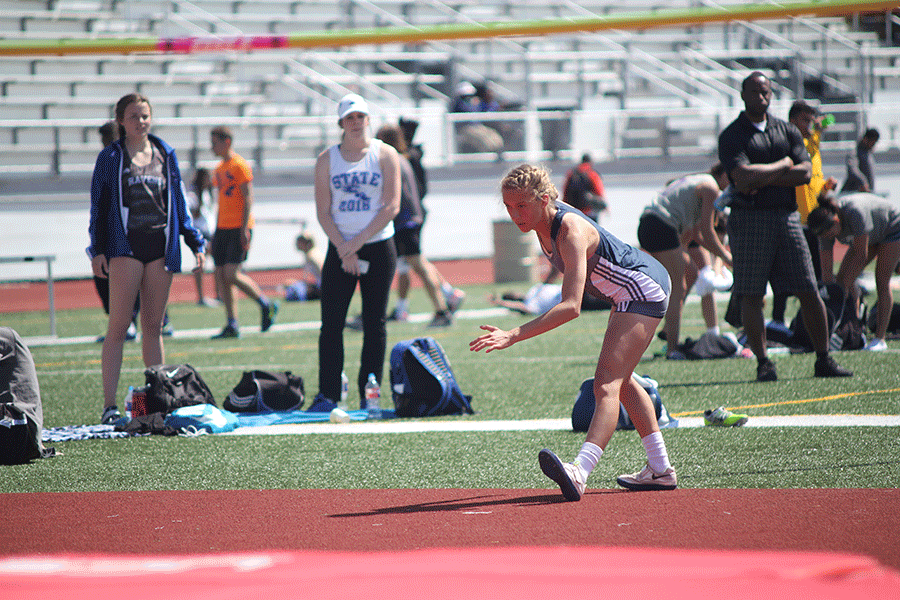 Before running toward the bar, senior Morgan Thomas prepares for her high jump.