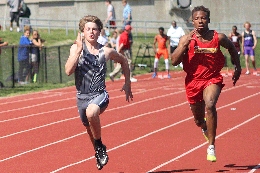 In the 100m dash, sophomore Steven Colling sprints ahead of his competitor.