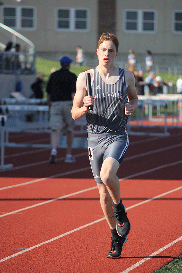 Running in the 4 by 8 relay, junior Isaac Knapp finishes his final lap.