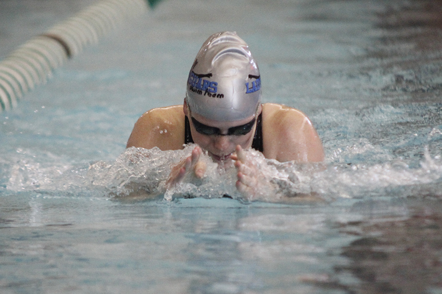 Freshman Kayla Teasley takes a breath before plunging her hands forward and continuing her stroke.