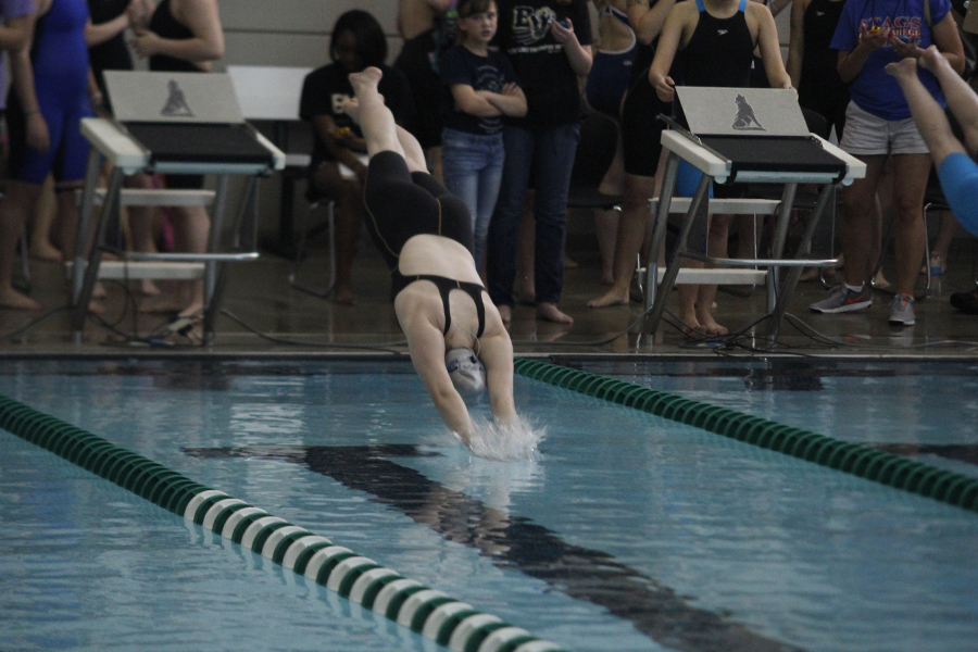 Freshman Kayla Teasley dives into the water to start her event.