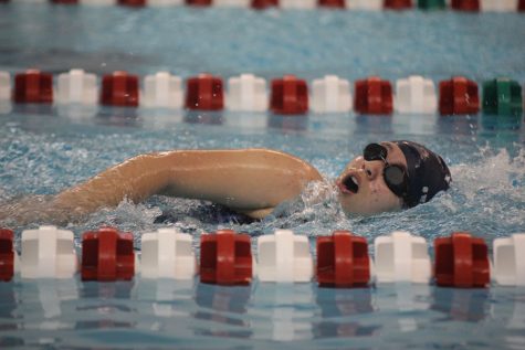 During a swim meet hosted by Blue Valley West on Tuesday, May 2, sophomore Lyrik Cooper swims in the freestyle event. 