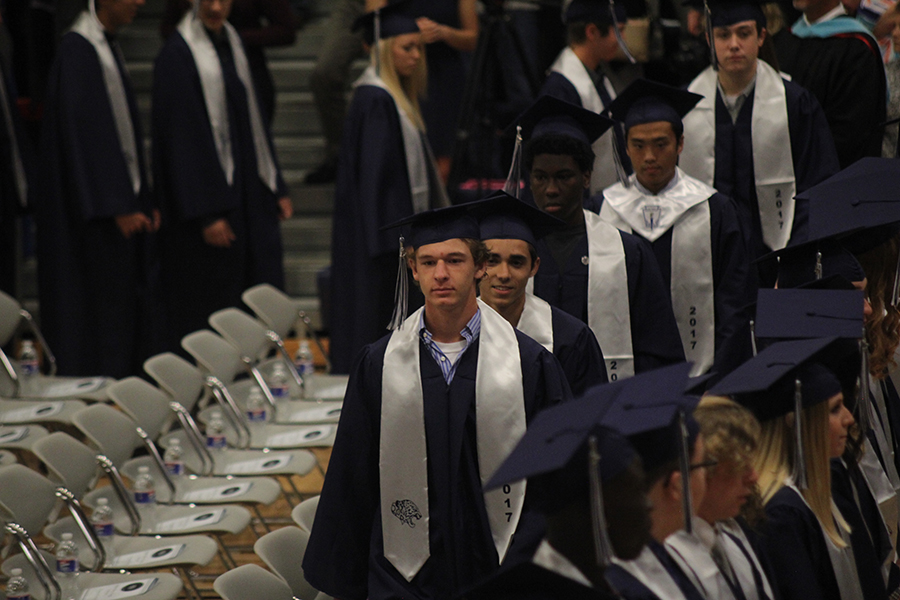 Walking to his seat, senior Alec Bergeron gets ready to graduate. 