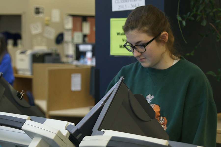 Standing at a voting booth on Friday, April 28, Junior Aly Tennis selects her top candidates for student body StuCo positions. I think that voting like this prepares you for actually voting in the real world and getting that interaction, so I think its a lot better than doing paper, Tennis said.