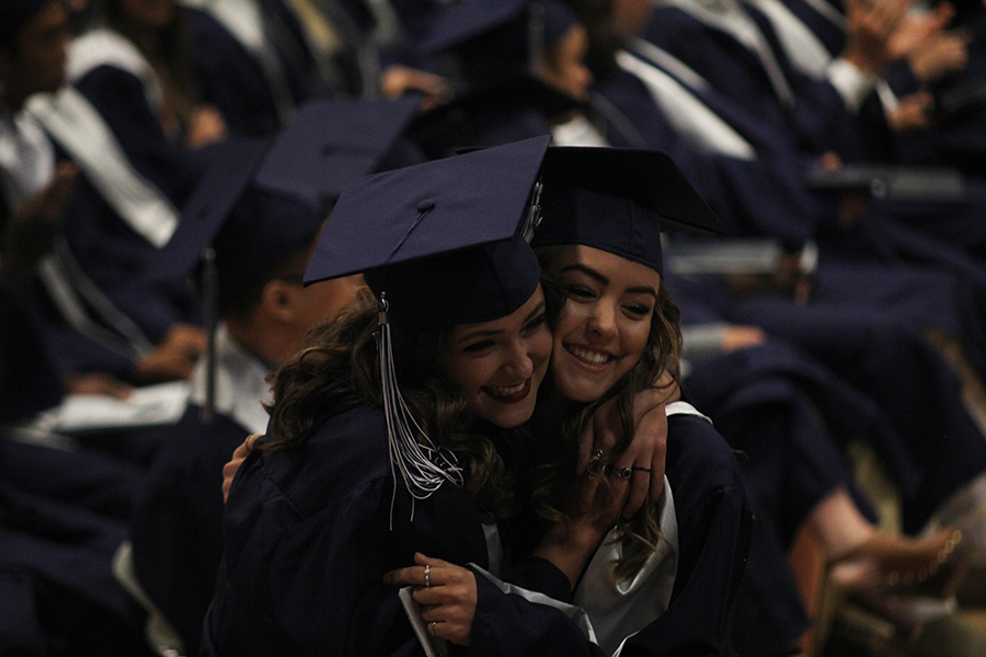 Seniors Savannah Sunderman and Shelby Suman take a photo before walking across the stage to receive their diploma. 